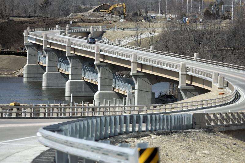 A bridge with several levels and a few cars on it.